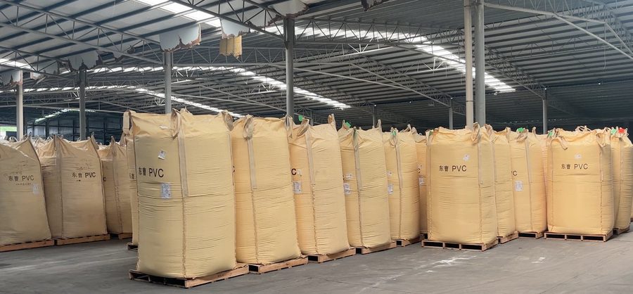 PVC resin raw material bags — yellow ton bags on pallets