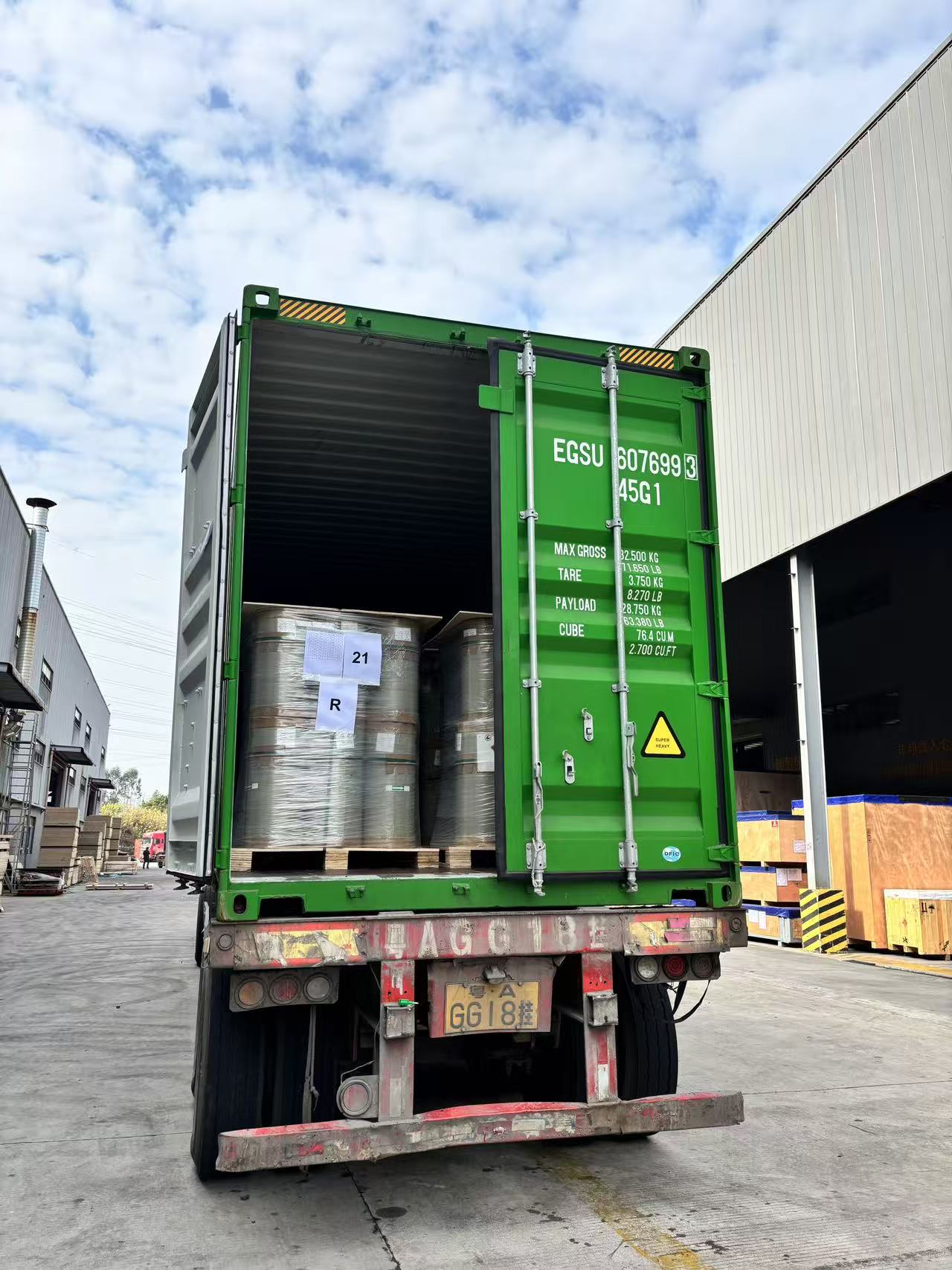 Green shipping container loaded with BESUN DECOR film rolls