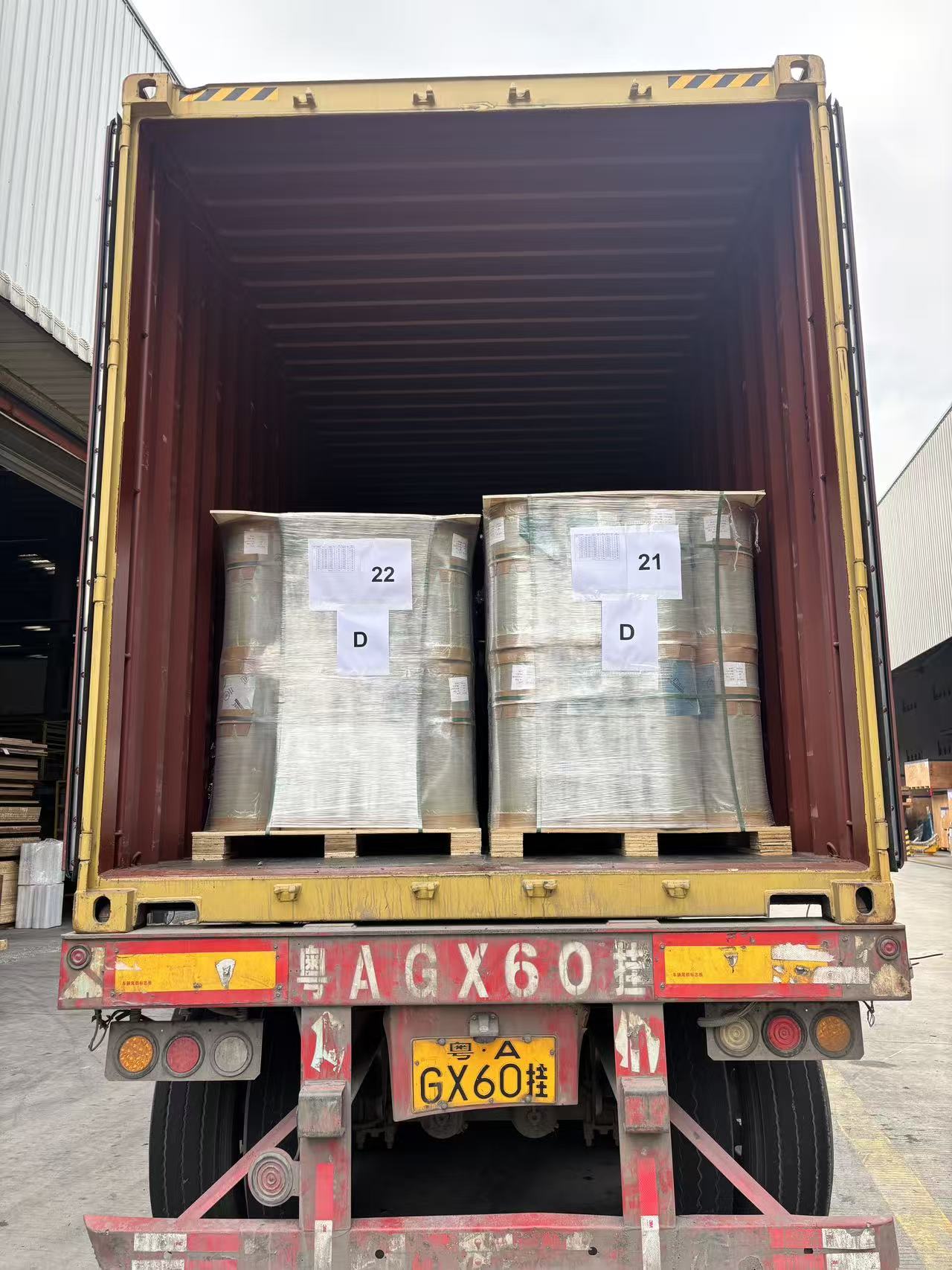 Container interior showing two large palletised rolls ready for export